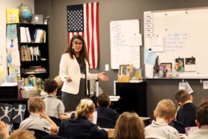 Teacher standing in front of a group of students.